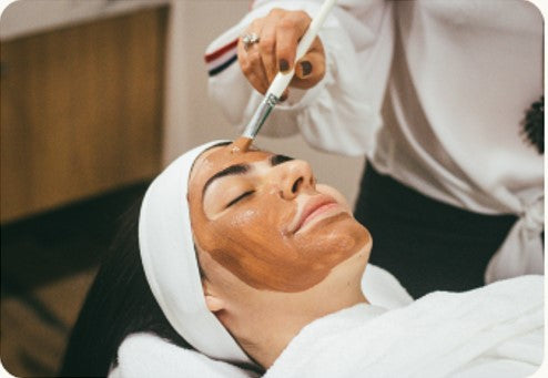 woman relaxing and enjoying a customised facial in the comfort and safety of her home